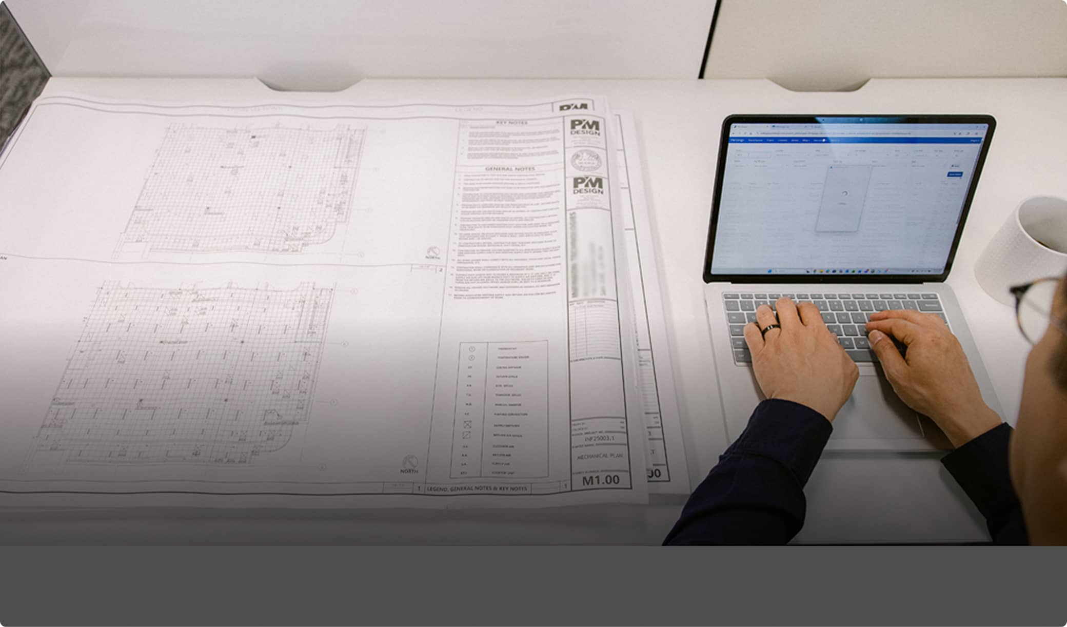 aerial view of architectural drawings and laptop