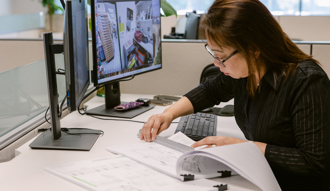 PM Design employee at desk
